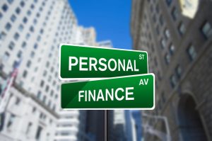 green and white street sign with one sign as personal and the other as finance